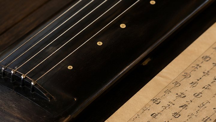 Guqin strings, hui markers, lacquer surface, and traditional score paper
