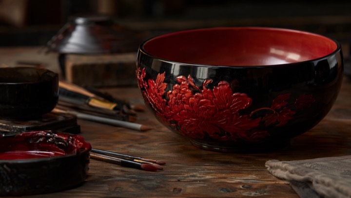 Chinese lacquerware bowl with black and cinnabar lacquer on a craft table
