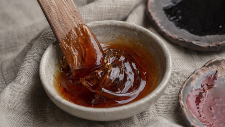 Natural lacquer material, pigments, brushes, and lacquer samples on a worktable